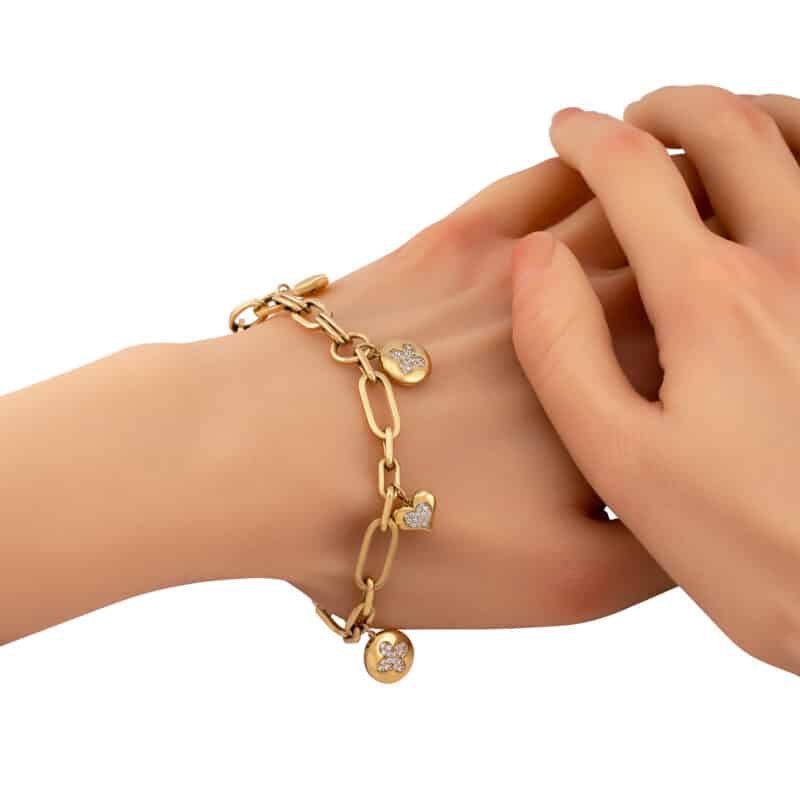 Bransoletka z żółtego złota z podłużnymi ogniwkami i wiszącymi zawieszkami ozdobionymi białymi cyrkoniami 82411